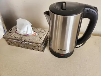 a black and silver coffee pot and a box at citadel mountain sun guest house in Amman