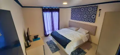 a small bedroom with a bed and a window at citadel mountain sun guest house in Amman
