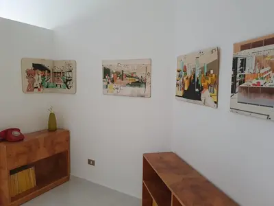 a room with a staircase and pictures on the wall at One-of-Kind home - city & nature in Amman