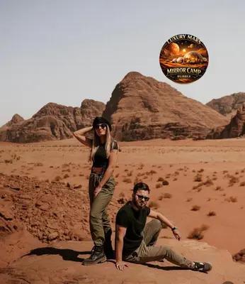 a man and a woman standing in the desert at MARS MIRROR BUBBLE lUXURY CAMP in Wadi Rum