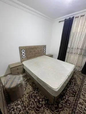 a bedroom with a bed and a chair in it at Ara Home in Amman