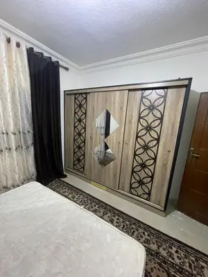 a room with a bed and a wooden wall at Ara Home in Amman