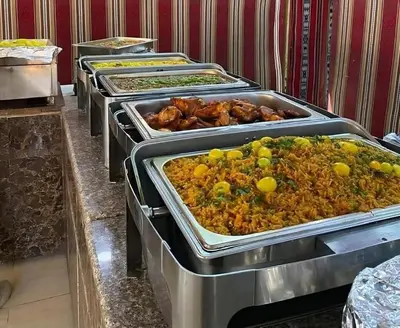 a row of trays of food on a buffet at Wadi Rum Jeep Tour Sleeping under the stars in Wadi Rum