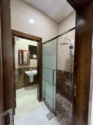 a bathroom with a glass shower and a sink at Osama Alnaser in Amman