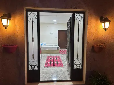 an open door to a room with a bedroom at Qastal Zaman in Amman