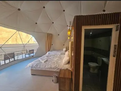 a bedroom with a bed in a tent at CAPITAL RUM lUXURY CAMP in Wadi Rum