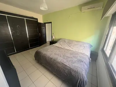 a bedroom with a bed and a window at Modern, fully equipped apartment in Jabal Amman in Amman