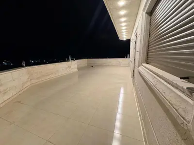 an empty balcony at night with lights on it at شقه مفروشه حديثة ذات أطلالة جميلة ومكان هادئ in Irbid