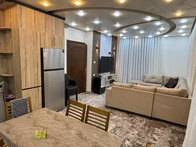 a living room with a couch and a table at شقه مفروشه حديثة ذات أطلالة جميلة ومكان هادئ in Irbid