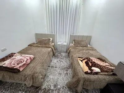 a room with three beds in a room at شقه مفروشه حديثة ذات أطلالة جميلة ومكان هادئ in Irbid