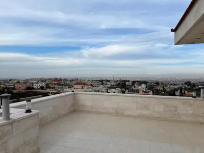 a balcony with a view of a city at شقه مفروشه حديثة ذات أطلالة جميلة ومكان هادئ in Irbid