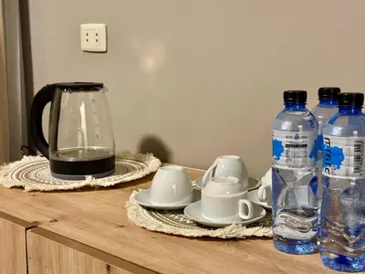 a table with a blender and two bottles of water at Beit Ahlan in Amman