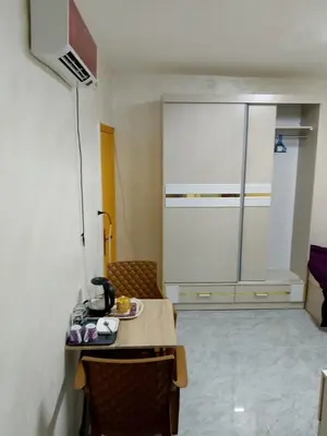 a room with a table and chairs in a room at Ahmad Hostel in Kerak