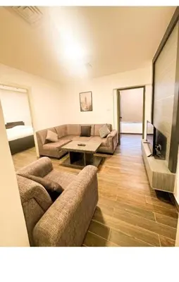 a living room with a couch and a table at الجوهره in Amman