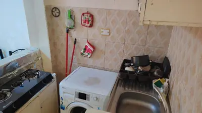 a small kitchen with a stove and a microwave at stone house in Amman