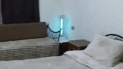 a bedroom with a bed and a chair and a table at stone house in Amman