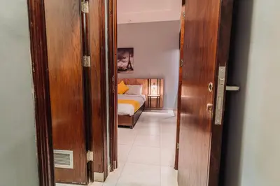 a door to a bedroom with a bed in a room at Baden Hotel Suites in Amman