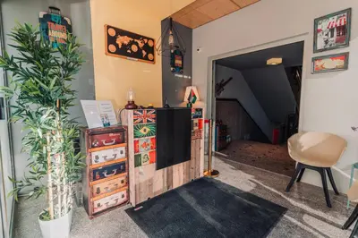 a living room with a tv and some plants at Baden Hotel Suites in Amman
