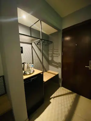 a small kitchen with a counter and a sink at Baden Hotel Suites in Amman