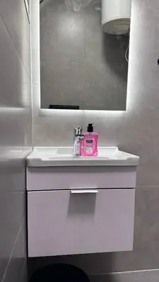 a bathroom with a pink soap dispenser on a sink at One bedroom near University of Jordan in Amman