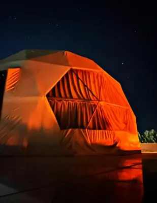 an object is lit up with orange light at Olivia Rum Luxury Bubbles & Jeep Tours in Wadi Rum