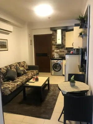 a living room with a couch and a table at Abdoun studio in Amman
