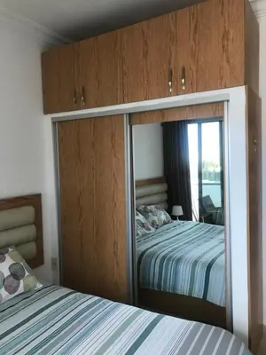 a mirror in a bedroom with a bed at Abdoun studio in Amman