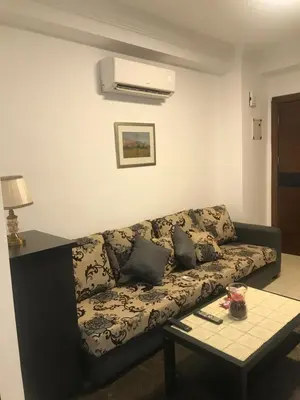 a living room with a couch and a table at Abdoun studio in Amman