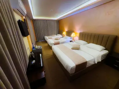 a hotel room with two beds and a television at 7Wonders by TREND in Petra