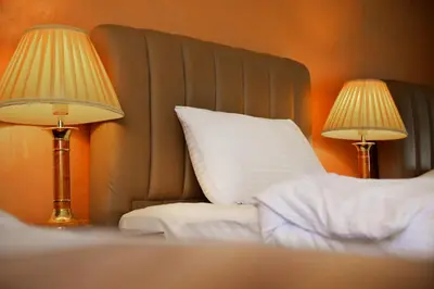 a bedroom with a bed with two lamps on it at 7Wonders by TREND in Petra