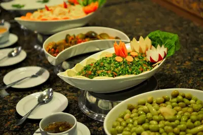 a table topped with bowls of different types of food at 7Wonders by TREND in Petra