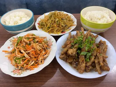 three plates of food on a table with rice at \u9f99\u95e8\u5ba2\u6808 in Amman