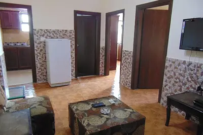 a living room with a couch and a table at Al-Nujoom Hotel Suites in Amman