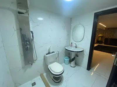 a bathroom with a toilet and a sink at CityHaven in Amman