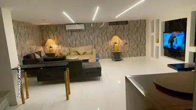 a living room with a couch and a tv at CityHaven in Amman
