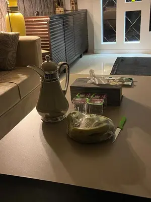 a tea kettle on the floor of a living room at CityHaven in Amman