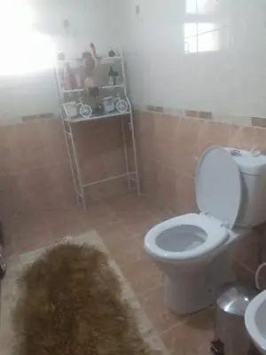 a bathroom with a white toilet and a sink at جبيهه in Amman