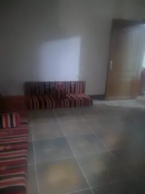 a room with a couch in the middle of a room at جبيهه in Amman