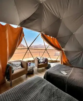 a room with a tent with a view of the desert at Rum STAR LUXURY Camp &JEEP Tours in Wadi Rum
