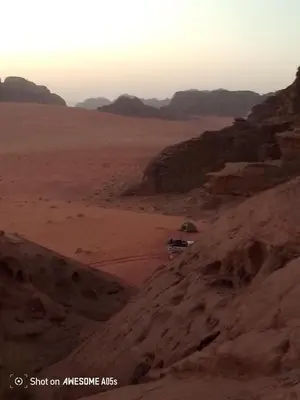 a car driving down a dirt road in the desert at Ragheb Al-Zawaida in Disah