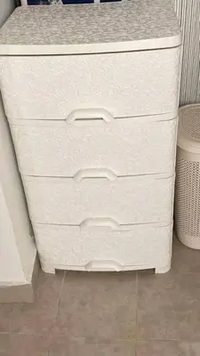a stack of white dressers in a room at Aqaba Drought inn in Aqaba