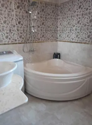 a bathroom with a bath tub and a sink at Aqaba Drought inn in Aqaba