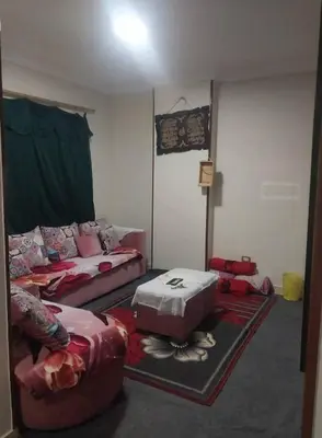 a living room with two beds and a couch at Aqaba Drought inn in Aqaba