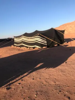 a kite laying on the ground in the desert at Bedouin house in Wadi Rum