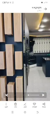 a room with a door and a wall with wooden boxes at فيلا اربد طريق البترول in Juḩfīyah