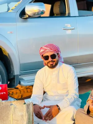 a man sitting on the ground next to a truck at Rum drone tours in Aqaba