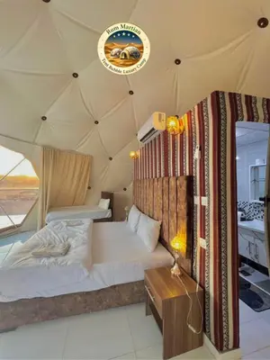a bedroom with a bed in a tent at RUM MARTIAN TENT BUBBLES lUXURY CAMP in Wadi Rum