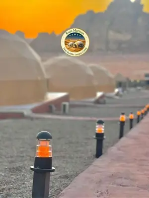 a row of black poles with a sign on it at RUM MARTIAN TENT BUBBLES lUXURY CAMP in Wadi Rum