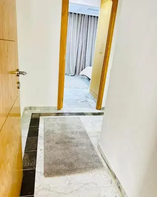 a hallway with a door and a tiled floor at Loard House in Az Zarqa