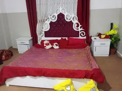 a bedroom with a bed with two dogs sitting on it at Loard House in Az Zarqa